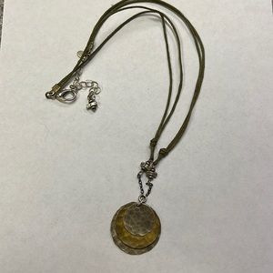 Sterling silver and brass metal pendant on olive green two-strand cord n…